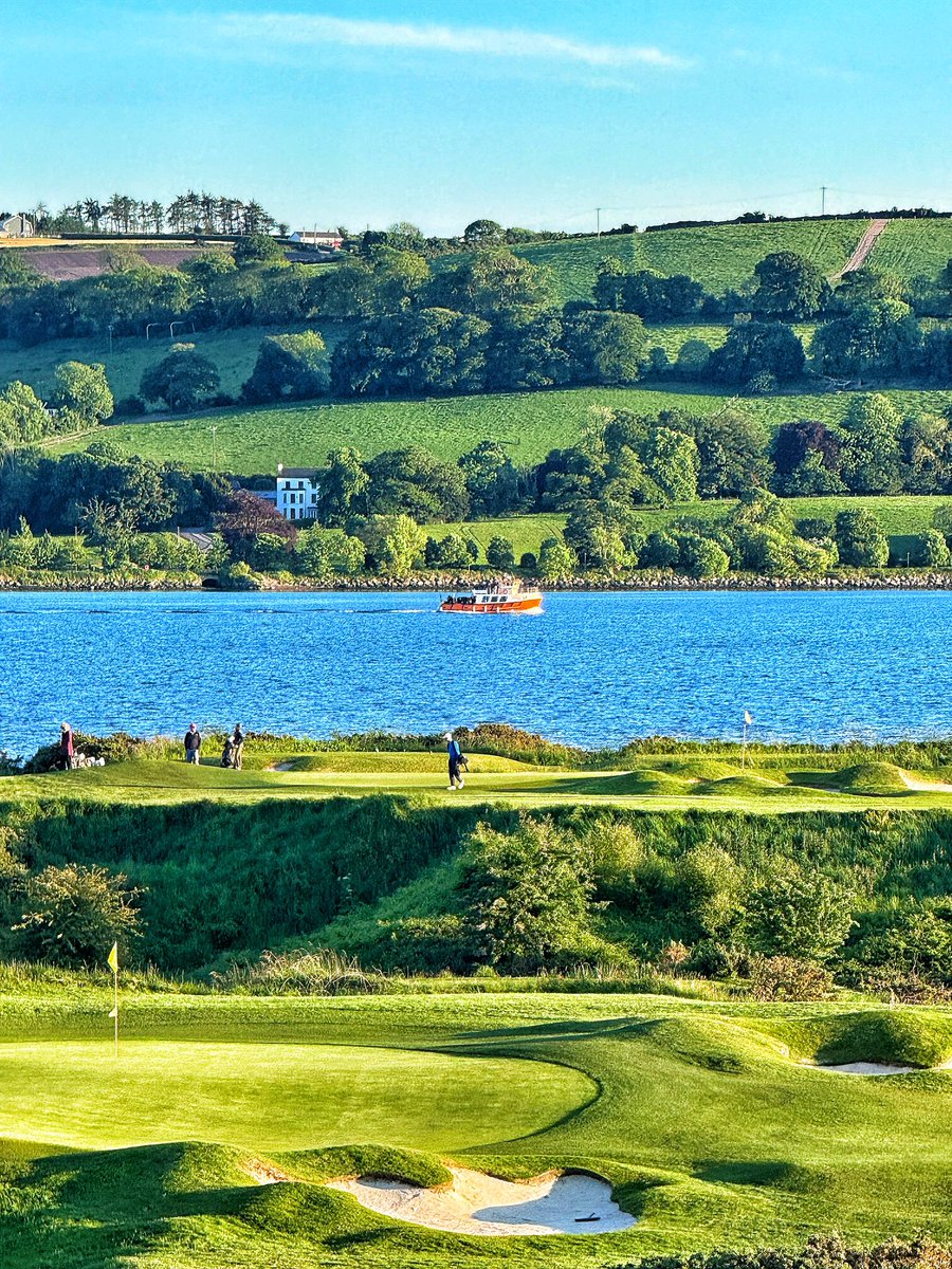 A trawler chugging up the harbour past the 4th Green and 5th tee.