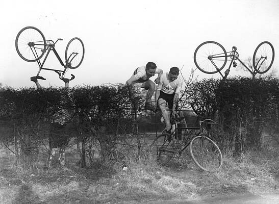'A hedge is tackled in a fiercely contested cross country run between cyclists and harriers in a meeting at Enfield, Middlesex.'
1932