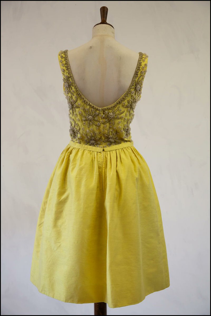 This week's #FridayFrills is this 1960s yellow silk cocktail dress embroidered with glass beads and rhinestones in the shape of flowers or stars. And it has a nice little bow in front 😉. It was sold online for only $202. #YellowMay #Fashionhistory