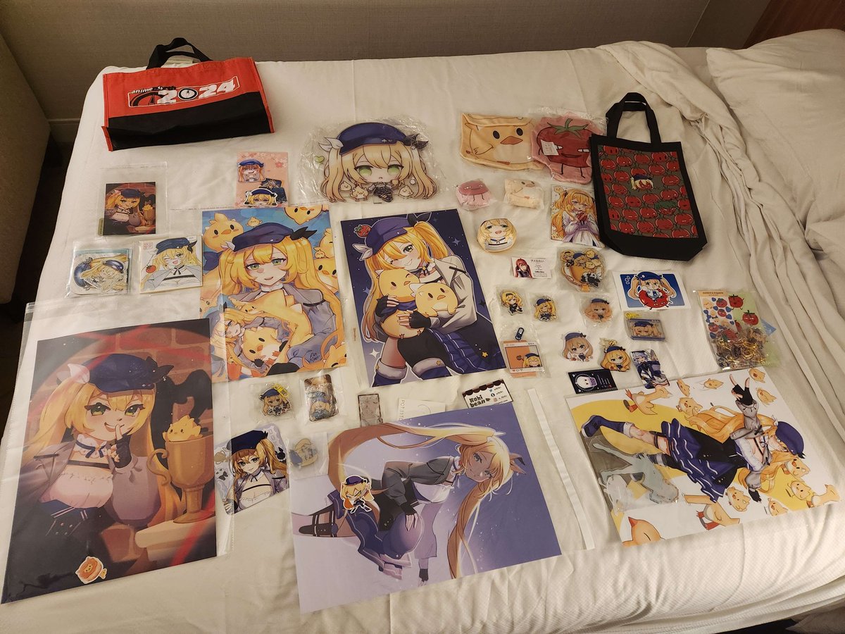here's all the stuff the convention staff got for me at artist alley 🥳