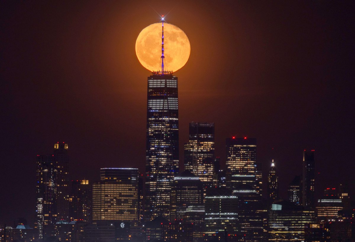 A 96 percent illuminated waning gibbous Flower Moon rises behind lower Manhattan and One World Trade Center in New York City, Friday evening #newyork #newyorkcity #nyc #moon #flowermoon