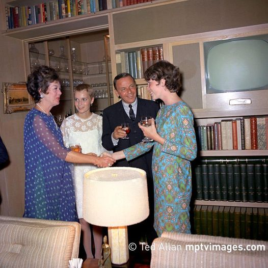 At the wedding in 1966…..Frank introduces Mia’s sister Prudence to actress Rosalind Russell…