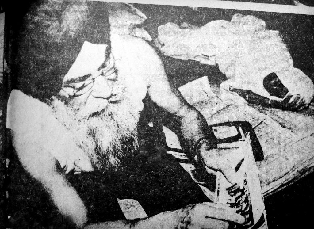 General Shabeg Singh showing a photograph of himself in Indian Army Uniform while his ailing wife is lying next to him, c. May 1984.