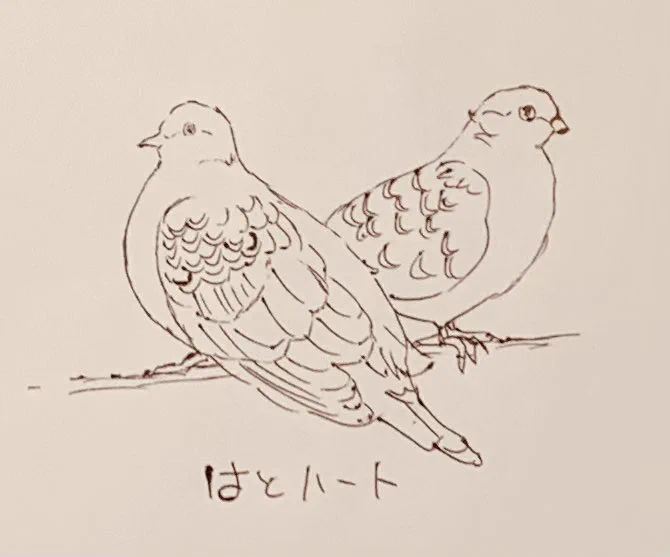 鳩が2匹ハート型にとまっていて可愛かったやつ、なんかの紋章っぽい 