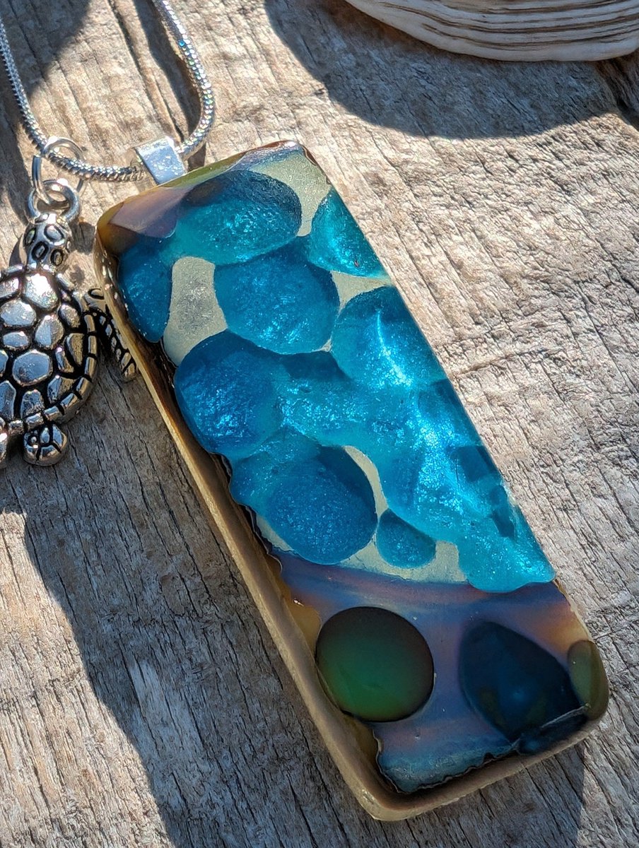 Love the detail in this unique rock pool and beach themed necklace. Beautiful shimmering blues within this handcrafted pendant. Perfect for the beach. #ukgiftam #ukgifthour #handmade #beachjewellery #giftideas #etsy #shopindie buff.ly/3USmVyE