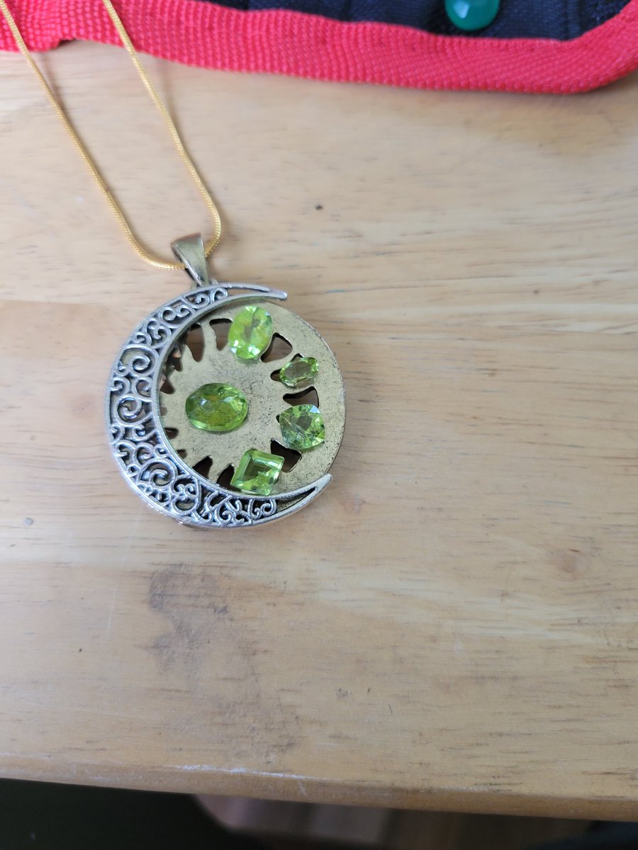 Custom piece for someone in Memphis TN 5 peridot set in a brass pendent and a Cresent moon made of silver.