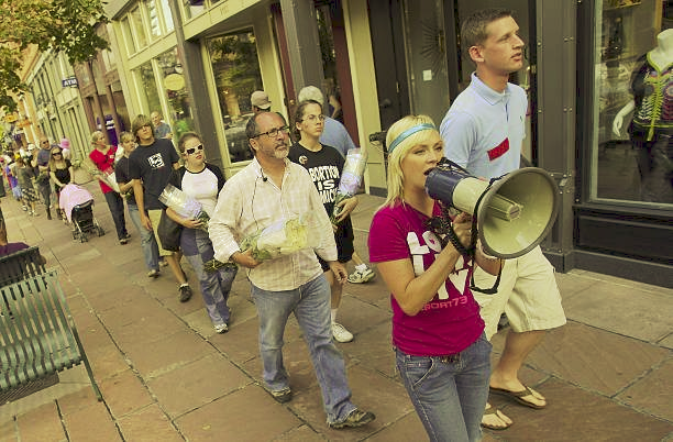 Circa  2008:  'It's a family affair!'  Kaitlin, aka 'Fembo,' leading a  peaceful witness calling for an end to abortion violence at the DNC in  Denver! Revolution is our family business! #OnWithTheRevolution #MahoneyStrong #WeWillNotBeSilenced