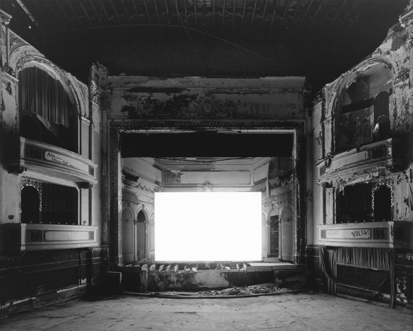 hiroshi sugimoto photographing a movie by pressing the shutter at the first scene and closing when the credits roll. “suppose you shoot a whole movie in a single frame? you get a shining screen.”