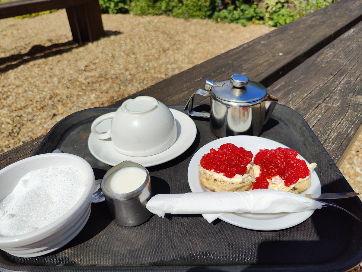 Should the clotted cream or jam go first on a scone?

And let's not get into a debate about the pronunciation of a scone.