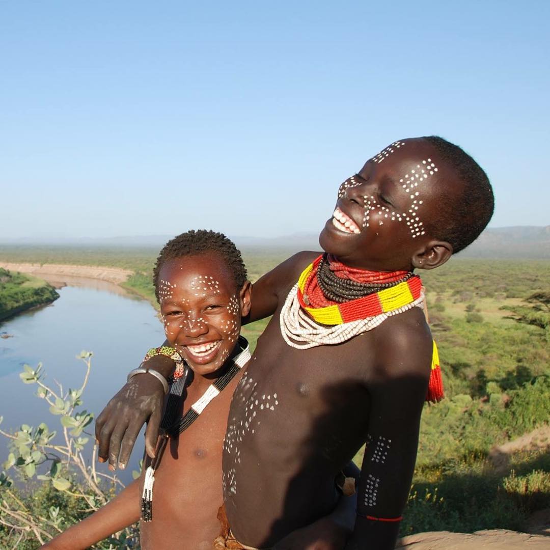 ITS ALL ABOUT BEING HAPPY WHEREVER YOU LIVE!!
Two ethnic Karo sisters laughing happily at their Omo River Valley area in Ethiopia. Behind them is the Omo River. The Karo, also known as Kara. 
#Africa #weafricannations #VisitEthiopia 
@visiteth251