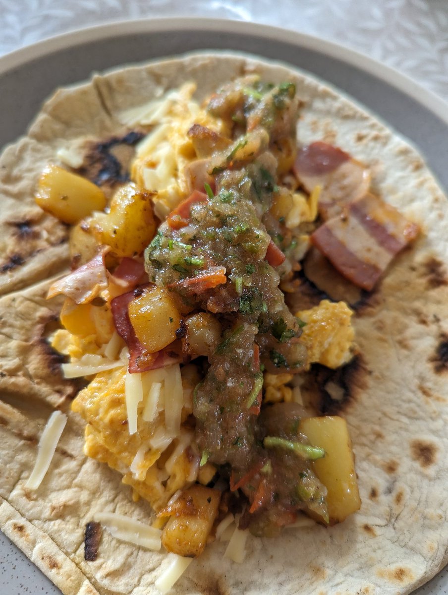 FoodBastard's tweet photo. Breakfast taco. Totties, eggs, cheese, veggie bacon, some breakfast salsa. All blasted on a homemade flour tortilla. https://t.co/LdAheB8uGL