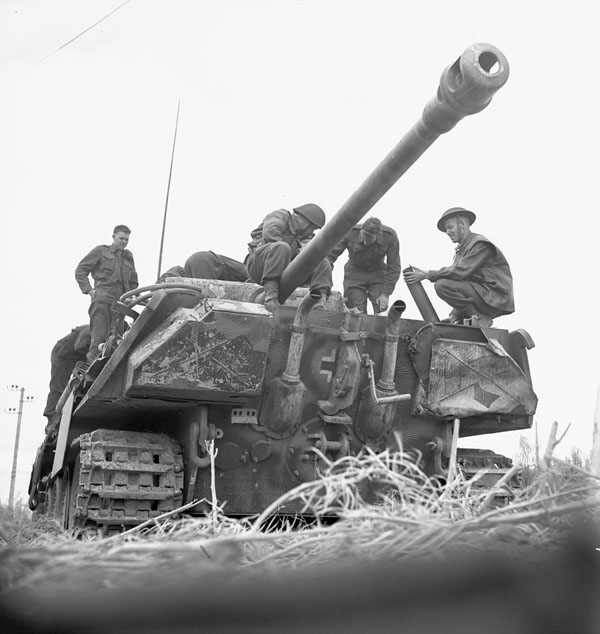 Infantrymen of the 7th Canadian Infantry Brigade examining a disabled German Pz Kpfw V Panther tank, Authie, France, 9 July 1944.