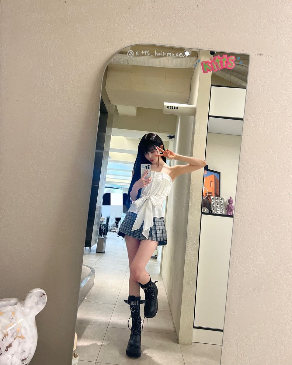 In the warm embrace of light, she captures a fleeting moment, her playful wink and delicate poise radiating an enchanting blend of elegance and whimsy.