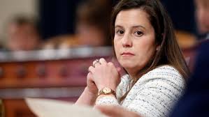Elise Stefanik is gazing at Stephen Miller and thinking: 'I'm picturing him without his scaly shell and 58 legs' 'I'd wear his armband to prom' 'If he kissed me I'd die. That's what scientists say' 'I'd climb him like a tree with Dutch Elm disease' 'He's my cicada with benefits'