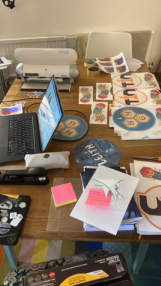 HatLeith's tweet photo. My current working situation in the lead up to @UKGamesExpo is chaos but getting stuff DONE! Featuring banner transfers for @HiveMindCreates and @uk_tabletop and vital postit notes so I don’t forget anything https://t.co/iY7f97tMw2