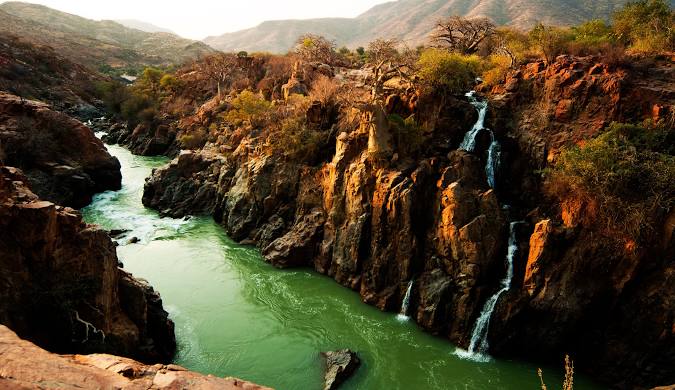 Where Angola ends, Namibia begins. My late wife was of the Swazi Kunene clan, and I always thought the Kunene River was one of Africa's least appreciated major rivers, flowing from the Angola highlands to the Atlantic. Ruggedly beautiful, it's fed by hundreds of waterfalls.