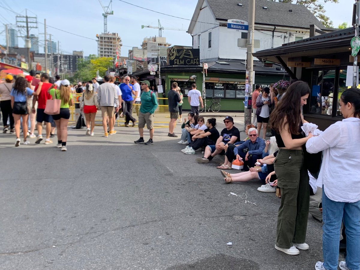 moore_oliver's tweet photo. The amazingly popular pedestrian Sunday in Toronto’s Kensington Market offers basically no where to #sitTO. Either buy something from a local business or your options are a concrete barrier and the curb https://t.co/mZHG5D8rwn