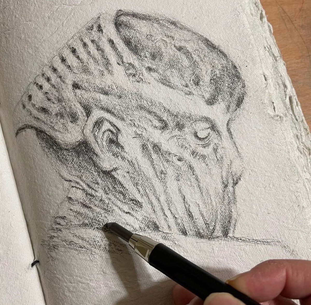 One of my favorite #sketches done in a #handmadepaper sketchbook. The organic textures help form eerie imagery like this gaunt specter fellow.
Love to let my mind drift and pencil flow on these surfaces. 
#creaturedesign #illustration