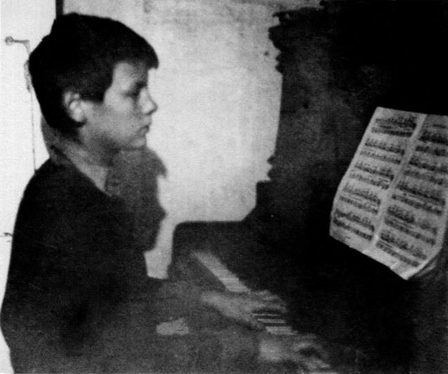 Young Andrei Tarkovsky learning to play the piano at a music school.