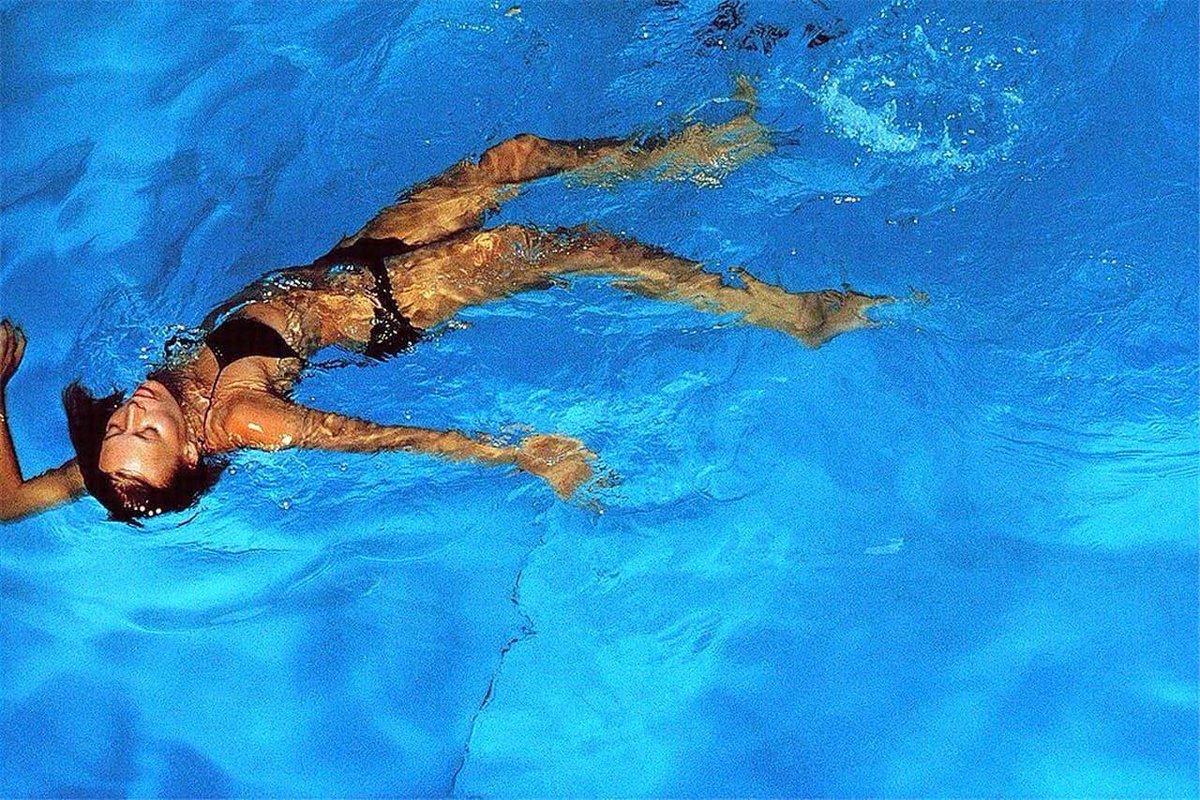 'Hissing of Summer Lawns' series: Joni Mitchell in her swimming pool (Los Angeles, 1975) by Norman Seeff