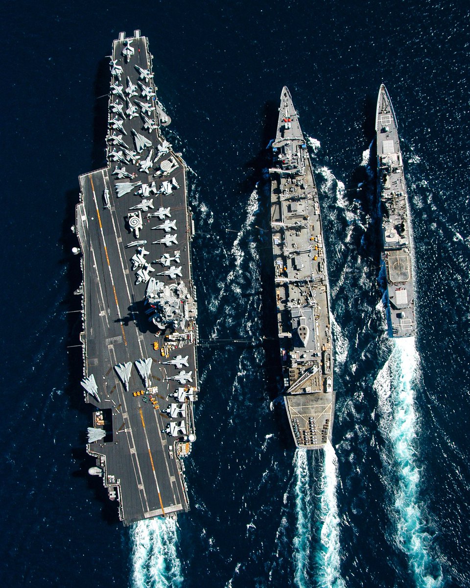 The guided missile cruiser USS Gettysburg, right, and the aircraft carrier USS Enterprise (CVN 65) left underway alongside the fast combat support ship USS Detroit (AOE 4) during a replenishment at sea in 2003. (pearlman)