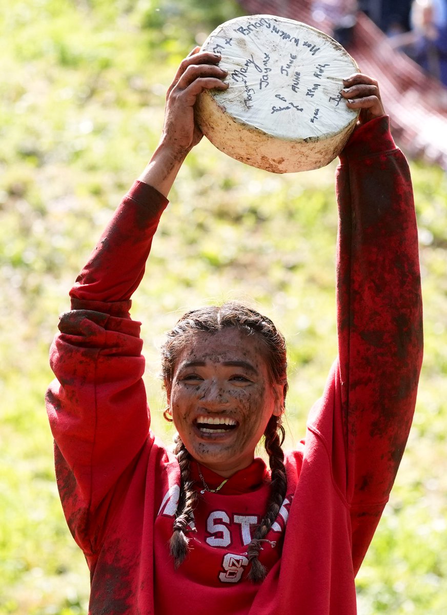 PackPride's tweet photo. Congratulations to Abby Lampe on winning the Cooper’s Hill Cheese Roll Race for a second time!

NC State is now a cheese rolling school! 🐺🐺 https://t.co/tvpXZmizRj
