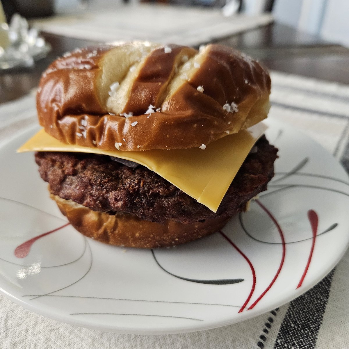 Lunch. 1/3rd lb. Sirloin Burger on King Hawaiian pretzel bun with cheese and onion. 38g protein.