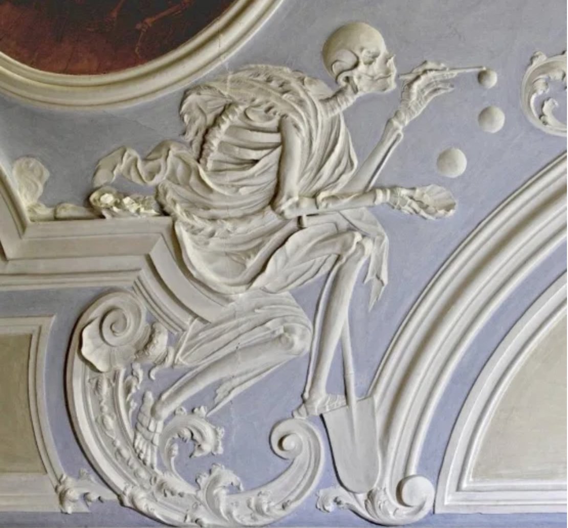 “Death blowing bubbles,” 18th century. The bubbles symbolize life's fragility. This plaster work appears on the ceiling of Holy Grave Chapel in Michaelsberg Abbey, Bamberg, Germany.
