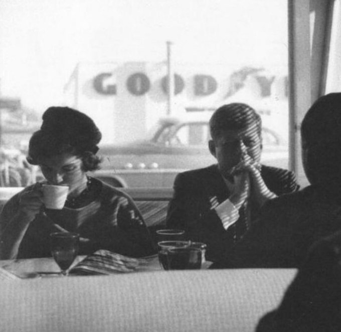 fasc1nate's tweet photo. JFK and Jackie at a diner in Oregon, 1959. As Kennedy sat in the diner, he was a senator at the time and still relatively unknown in most parts of the country. He hadn't even officially announced that he was running for president.   

However, during this photo, he was on an unofficial campaign trail, and most members of the Democratic Party knew he would run. In fact, back in Washington, a "Stop Kennedy" movement was already underway from his competitors.    

Throughout 1959, Kennedy traveled the length and breadth of the land, with a full schedule of speeches and public appearances, combating critics and challengers attempting to derail his bid to win the Democratic nomination.   

He traveled all over: the Midwest, California, attended a Cubs game, met Stan Musial (famous Cardinals baseball player), and visited a West Virginia coal factory. Interestingly, he faced smaller crowds out west, and in this photo, taken in Oregon, he was a virtual unknown.

"In Oregon," recalled photographer Jacques Lowe, who traveled with JFK for part of 1959, "Kennedy walked into a union hall to find eleven men waiting to hear him." Undeterred, according to Lowe, JFK didn't miss a step. "Without hesitation, he launched into his speech."