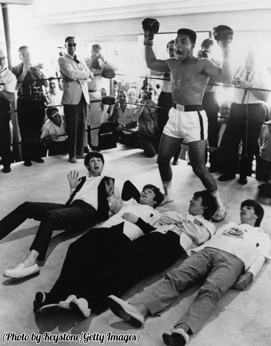 Muhammad Ali in a mock victory pose over The Beatles in New York, 1964.