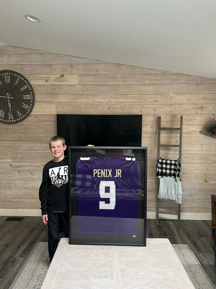 prherington's tweet photo. One happy kiddo with his Michael Penix Jr. jersey framed!!!  Go Dawgs! 💜💛@themikepenix https://t.co/trJknwa63B
