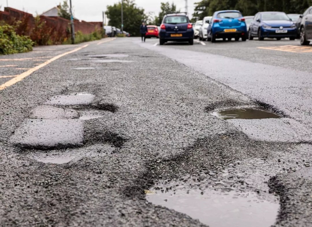NEWS: It's official, a survey has revealed Wigan's roads now have more holes than a Polo mint factory.
