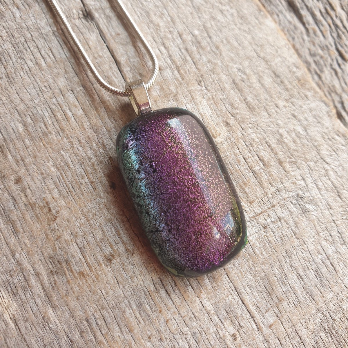 Amazing sparkling purples and greens within this unique handcrafted dichroic glass necklace. Stunning pendant. #handmade #etsy #giftideas #shopindie #etsyuk buff.ly/48CqYFg