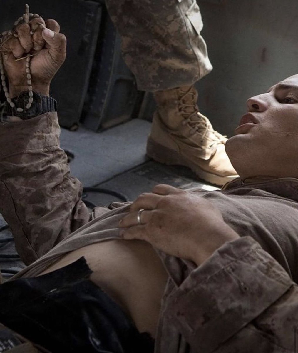 Blas Trevino clutches his rosary beads on a medevac helicopter from US Army's Task Force Lift 'Dust Off,' he got shot in the stomach in Helmand Province Afghanistan, he recovered from his wounds.