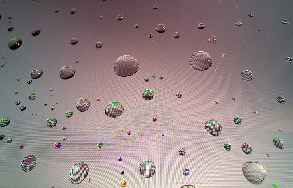 Image of the Week: Droplets on Display Close-up image of water droplets on a smartphone screen with a light gray background. Read more here: ow.ly/JRFG50yThjQ #droplets #water #smartphone #light #pixel #colors