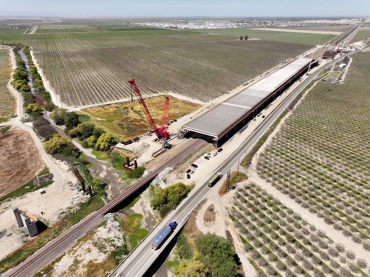 CaHSRA's tweet photo. The Tule River Viaduct is currently under construction and spans over 3,500 feet long, including a pergola structure that is comprised of 264 pre-cast concrete girders.

The viaduct will take HSR  trains over SR 43, BNSF railroad, and Tule River. #InfrastructureMonth #BuildHSR https://t.co/XHXbIBteqx