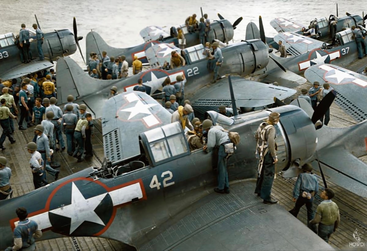 In August of 1943, pilots clamber out of the cockpits of their Douglas Dauntless aircraft aboard the USS Lexington, following a raid on Tarawa. ✈️