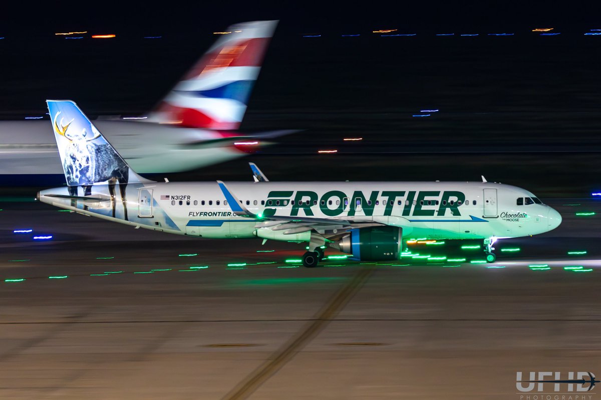 Tails passing by each other for #tailtuesday 
Frontier A320neo (N312FR “Chocolate the Moose”) taxis by a British Airways B789 (G-ZBKR) at Houston IAH 

F/5, ISO 3200, 1/6 sec shutter speed 

#frontierairlines #airbus #airbus320 #a320 #a320neo #airbuslovers #neolovers #n312fr