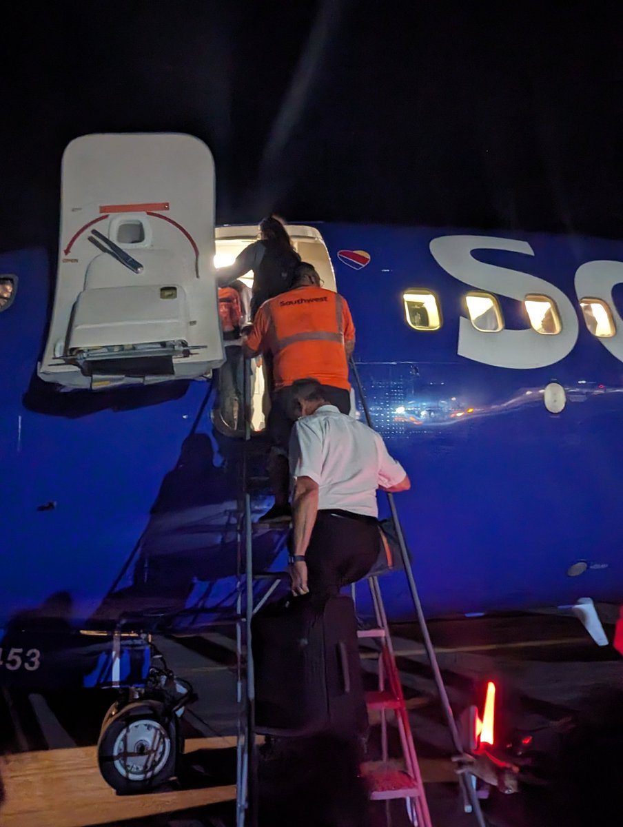 arosine's tweet photo. Props to the captain (shown here carrying passenger bags) and our @SouthwestAir crew for a long day of detours getting back to HOU from DEN after storms, dust storms, and short runway issues. Crew was super communicative, friendly, and patient with parents and kids alike. https://t.co/Dh7BS9aXj4