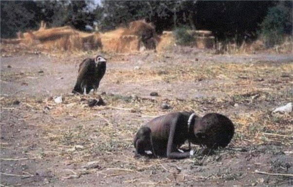 A starving Sudanese child crawls towards a United Nations feeding center while a vulture patiently waits for its next meal. This photo won a Pulitzer Prize, but the photographer, Kevin Carter, took his own life three months later.