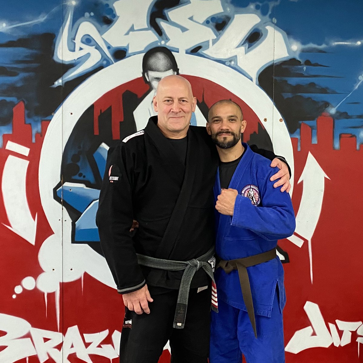 BJJ_NZ's tweet photo. Absolutely stoked to upgrade these two hard working loyal legends. Congrats Tola on the 14 year Brown Belt. And Yan on his well deserved Purple! https://t.co/s8gK7uqVIz