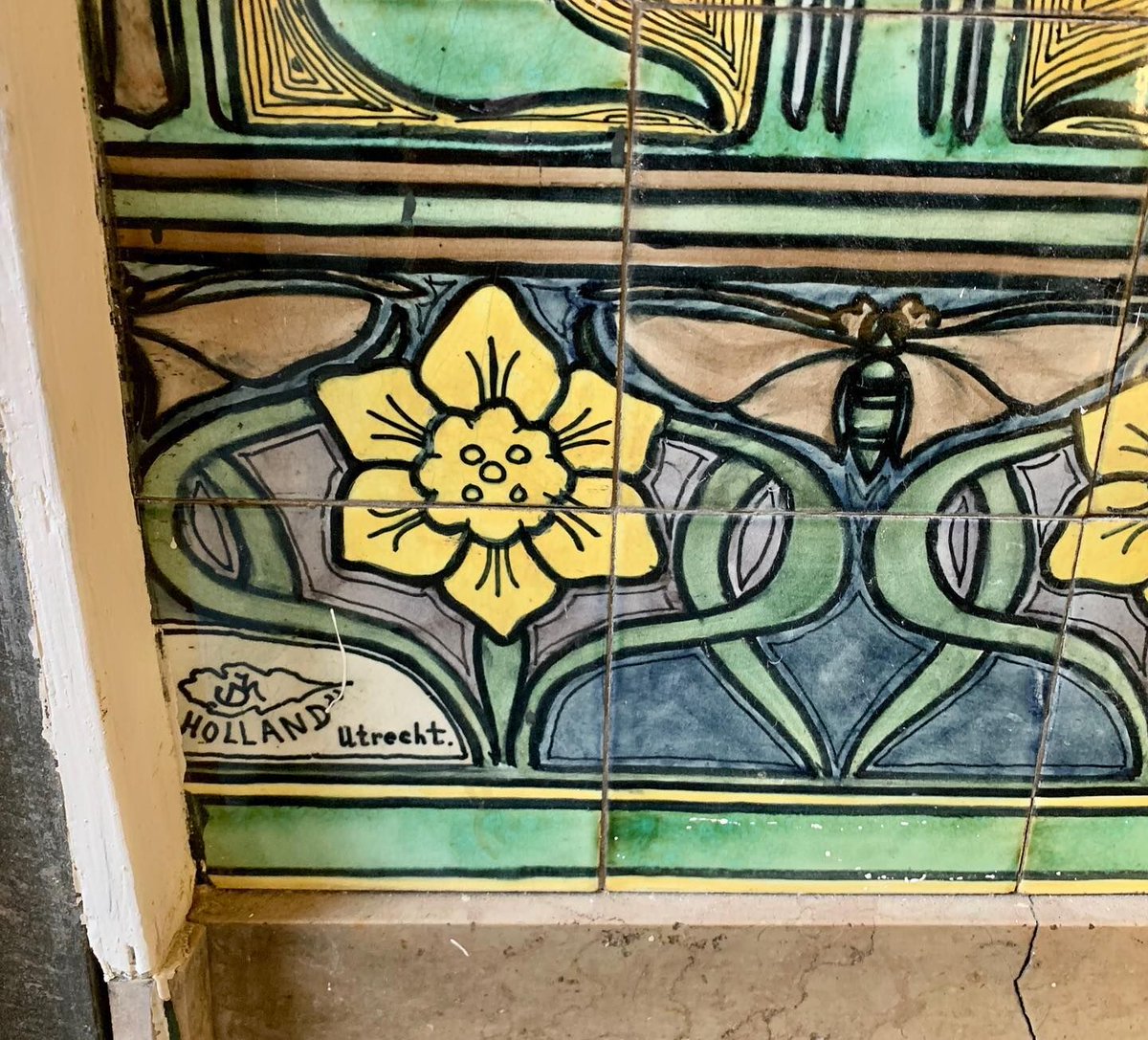 Art Nouveau tiles with a daffodil motif in the entrance at Van Vollenhovenstraat 23, Rotterdam, Netherlands. Built in 1897. Architect: J.C. Meyers