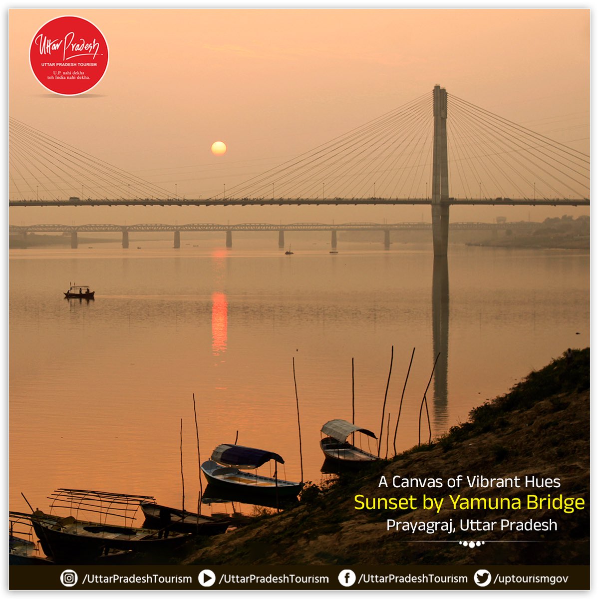 Experience the breathtaking sunset by the #YamunaBridge. As the sun dips below the horizon, the sky transforms into a canvas of vibrant hues, reflecting off the tranquil waters of the #YamunaRiver. This picturesque scene captures the serene & peaceful essence of #Prayagraj.