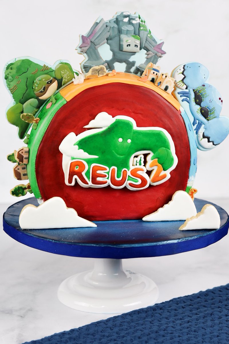 sugarhighscore's tweet photo. I created a cake world and 3 cookie giants to celebrate the launch of Reus 2! [ad] 🌎🎂 

In this game, you control giants to shape the world and help human civilization thrive. I loved making this cake especially the cookie giants! https://t.co/VPzHiPBIiN