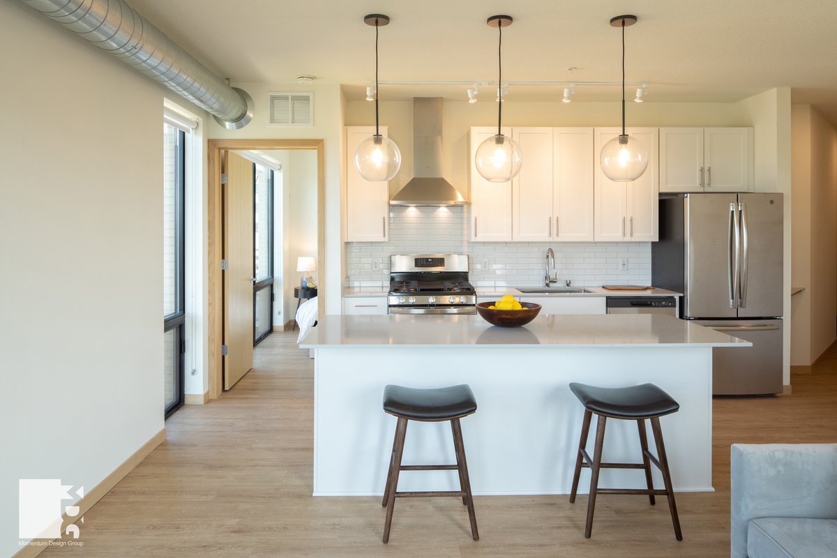 White oak-look floors, white cabinets and subway tile will always be a yes! You can find this timeless unit design at the Archive North Loop Apartments.

#mdgarchitects #apartments #apartmentdesign #apartmentliving