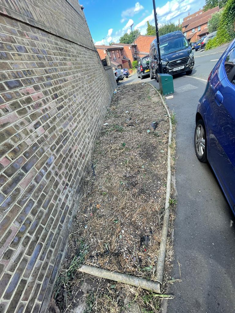 Stunning transformation on Oliver Close, off Thames Road. Before - weeds, membrane, gravel, cars blocking pavements :