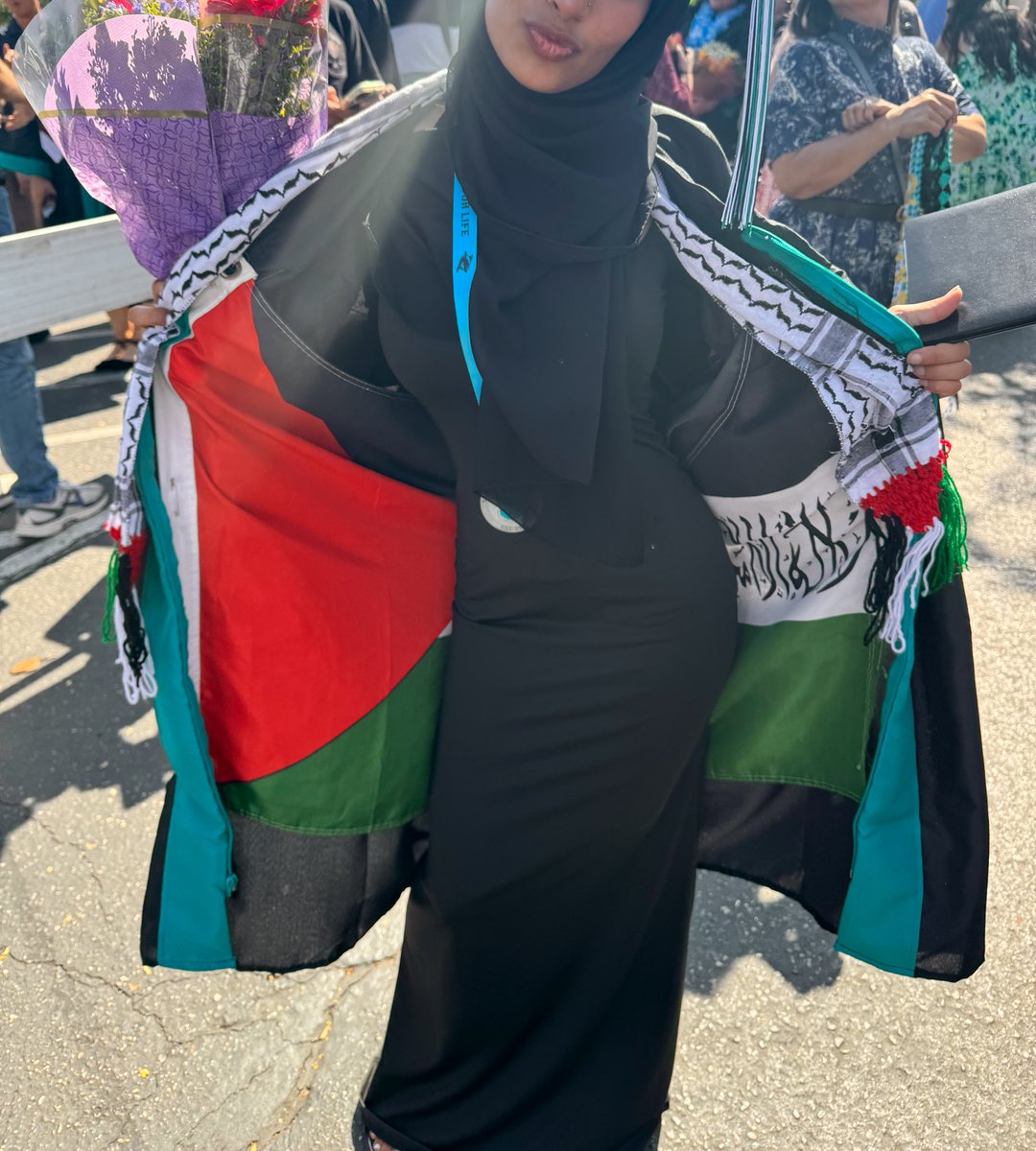 Our little graduate got her graduation hat taken away, so she pinned the Palestinian flag on the inside of her robe and opened it in the middle of the stage