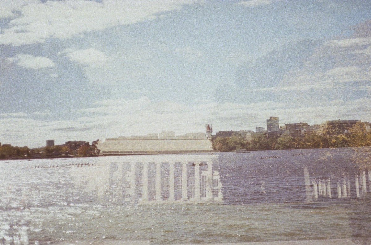 jlmcd_'s tweet photo. I have an old manual Canon that I often  forget to wind, so my photos overlap. Usually I end up with nonsense but sometimes things align just right and I get the most Boston photo of all time. I give you MIT dome in the Charles river with rowers below the citgo sign: https://t.co/6rX3vlAi7d