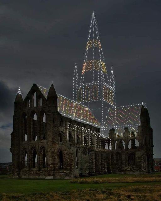 The ruins of Whitby Abbey, a 7th-century Christian monastery in England, recreated with drone lighting.