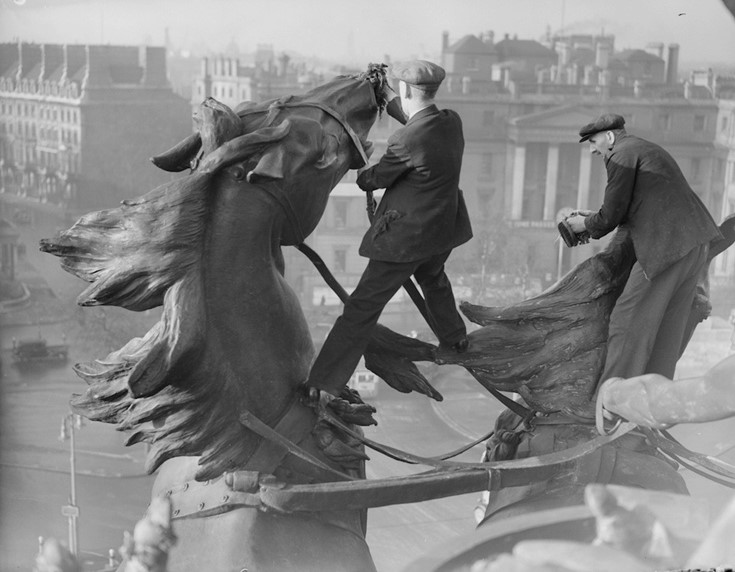 From our archive: It's 1939 and these daring, neatly-dressed cleaners are polishing ~ almost as if restraining! ~ the sculpted war chariot horses atop Wellington Arch on London’s Hyde Park Corner, part of the largest bronze sculpture in Europe (photo, Harry Todd)